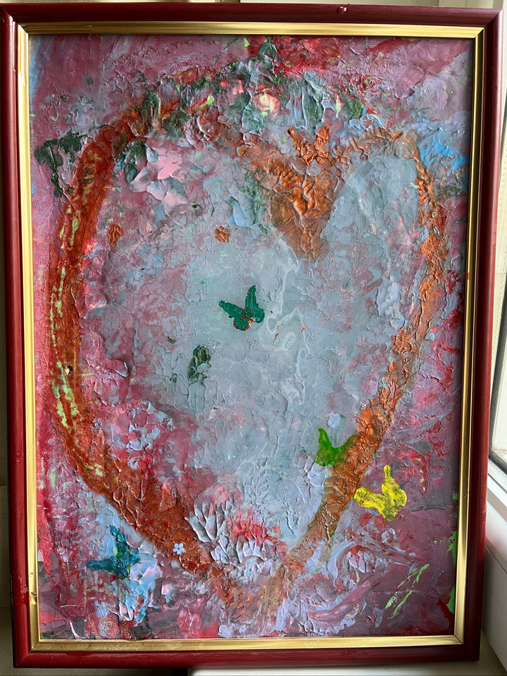 Abstract painting with a heart-like shape in a wooden frame